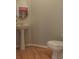 Small powder room with pedestal sink and toilet, hardwood floors at 104 Fox Den Cir, Statesville, NC 28677