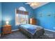 Bright bedroom with single bed, dresser, and whimsical wall decor at 104 Fox Den Cir, Statesville, NC 28677