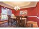 Formal dining room with red walls, hardwood floors, and chandelier at 104 Fox Den Cir, Statesville, NC 28677