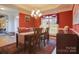 Formal dining room with red walls, hardwood floors, and chandelier at 104 Fox Den Cir, Statesville, NC 28677