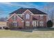 Brick two-story house with a large front yard and dark roof at 104 Fox Den Cir, Statesville, NC 28677