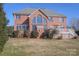 Brick house with a large deck and landscaped yard at 104 Fox Den Cir, Statesville, NC 28677