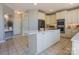 Open kitchen with white cabinets, large island, and stainless steel appliances at 104 Fox Den Cir, Statesville, NC 28677