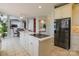 Bright kitchen features a large island with cooktop and a black refrigerator at 104 Fox Den Cir, Statesville, NC 28677
