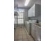 Laundry room with washer, dryer, cabinets, and overhead shelving at 104 Fox Den Cir, Statesville, NC 28677