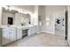 Double vanity bathroom with a view into another room at 11622 Morgan Horse Trl, Huntersville, NC 28078