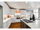 Modern kitchen with white cabinets, quartz countertops, and a farmhouse sink at 11622 Morgan Horse Trl, Huntersville, NC 28078