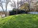 Large grassy backyard with stone accents at 12401 Olde Mill Stream Ct, Charlotte, NC 28277