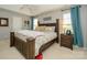 Large bedroom with a king-size bed and plenty of natural light at 12401 Olde Mill Stream Ct, Charlotte, NC 28277