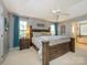 Main bedroom with a large bed, ceiling fan, and ensuite bathroom access at 12401 Olde Mill Stream Ct, Charlotte, NC 28277