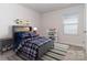 Virtually staged bedroom with gray bedding and window at 1334 31St St # 6, Conover, NC 28613