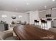 Virtually staged dining room with wood table and chairs, and living room view at 1334 31St St # 6, Conover, NC 28613