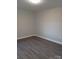 Light grey walls and dark grey vinyl plank flooring in this bright bedroom at 1408 Delview Rd, Cherryville, NC 28021