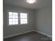 This bedroom has hardwood floors and a large window for plenty of natural light at 1408 Delview Rd, Cherryville, NC 28021