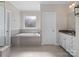 Bathroom with soaking tub and granite countertop vanity at 2262 Sweet Pea Ln, Harrisburg, NC 28075