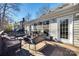 Spacious deck with wicker furniture, fire pit, and wooded backyard views at 2702 Oxborough Dr, Matthews, NC 28105