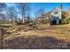 Spacious backyard with wooden deck, stairs, and a beautiful view of nature at 2702 Oxborough Dr, Matthews, NC 28105