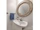 Charming powder room with pedestal sink and ornate circular mirror at 2702 Oxborough Dr, Matthews, NC 28105