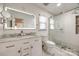 Updated bathroom features a double vanity, a large mirror, and a glass shower at 2702 Oxborough Dr, Matthews, NC 28105