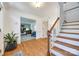 Bright entryway with hardwood floors, a staircase, and a view of a home office at 2702 Oxborough Dr, Matthews, NC 28105