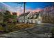 Two-story house with gray siding, white shutters, and a long driveway at 2702 Oxborough Dr, Matthews, NC 28105