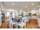Kitchen with white cabinets, a light blue island, and a dining table at 2702 Oxborough Dr, Matthews, NC 28105