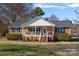 Brick ranch home with covered porch and landscaped yard at 331 Shoreline Loop, Mooresville, NC 28117