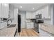 Modern kitchen featuring white cabinets and granite countertops at 331 Shoreline Loop, Mooresville, NC 28117