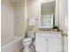 Clean bathroom with white vanity and a tub shower combo at 3922 Ayscough Rd, Charlotte, NC 28211