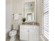 Updated bathroom with white vanity, tile flooring and a large mirror at 3922 Ayscough Rd, Charlotte, NC 28211