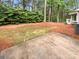 Wooded backyard with mature trees, shrubs, and small concrete patio at 4818 Whistling Oak Ct, Charlotte, NC 28269
