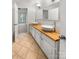Bathroom featuring a double vanity and mirror, with tile flooring and access to a bedroom at 4818 Whistling Oak Ct, Charlotte, NC 28269