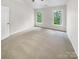 Bedroom with neutral carpet and two windows that provide natural light at 4818 Whistling Oak Ct, Charlotte, NC 28269