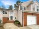 Inviting exterior of charming townhome featuring a brick facade and attached garage at 4818 Whistling Oak Ct, Charlotte, NC 28269