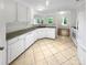 Bright kitchen with white cabinetry, granite countertops, and tile floor at 4818 Whistling Oak Ct, Charlotte, NC 28269