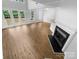 Open living room with hardwood floors, fireplace, and plenty of light from the windows at 4818 Whistling Oak Ct, Charlotte, NC 28269