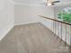 Loft area with carpet, white railing, natural light and view of lower level at 4818 Whistling Oak Ct, Charlotte, NC 28269
