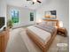 Inviting main bedroom with vaulted ceiling, carpet, and two bright windows at 4818 Whistling Oak Ct, Charlotte, NC 28269