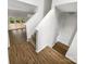 Stairway leading to an upper level loft from the living room, complete with hardwood floors at 4818 Whistling Oak Ct, Charlotte, NC 28269