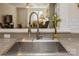 Modern kitchen sink with a gooseneck faucet and granite countertop at 5998 Village Nw Dr, Concord, NC 28027