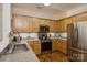 Modern kitchen with stainless steel appliances and light wood cabinets at 5998 Village Nw Dr, Concord, NC 28027