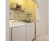 Laundry room with washer, dryer, and shelving at 5998 Village Nw Dr, Concord, NC 28027