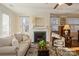 Living room features a fireplace and plenty of natural light at 5998 Village Nw Dr, Concord, NC 28027