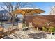 Private patio with brick pavers, umbrella, and seating at 5998 Village Nw Dr, Concord, NC 28027