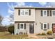 Gray townhouse exterior with front door and small patio at 6130 Heath Ridge Ct, Charlotte, NC 28210