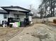 Backyard with a covered patio, gravel driveway, and wood fence at 7519 Marlbrook Dr, Charlotte, NC 28212