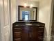 Bathroom with dark vanity, granite countertop, and a large mirror at 7810 Heatherdale Ct, Charlotte, NC 28212