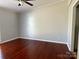 Simple bedroom with hardwood floors and neutral-colored walls at 7810 Heatherdale Ct, Charlotte, NC 28212