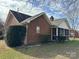 Brick house exterior with landscaped yard and porch at 8423 Quail Hollow Dr, Harrisburg, NC 28075