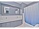 Bathroom with double vanity, gray walls and blue shower curtain at 936 23Rd Ne Ave, Hickory, NC 28601